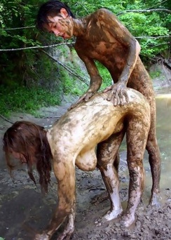 A Couple Have Fun Playing In The Mud