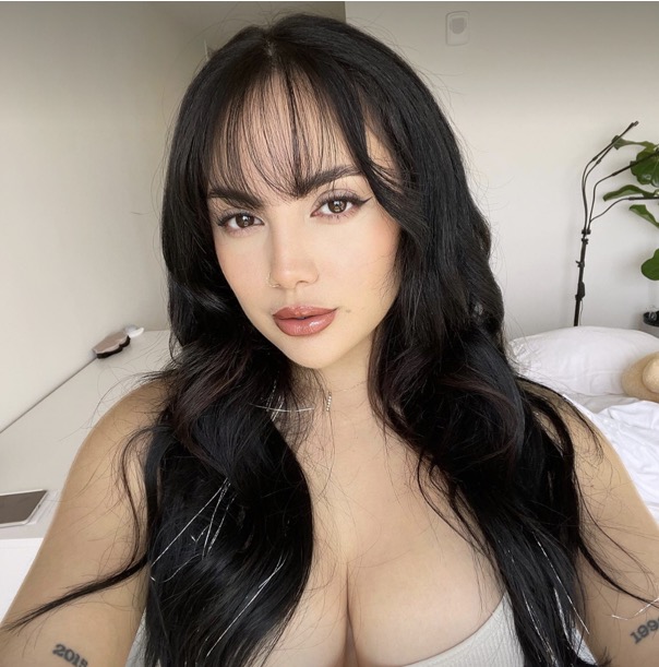 Beautiful OnlyFans model Nika Venom taking a sexy selfie with long black hair and seductive look